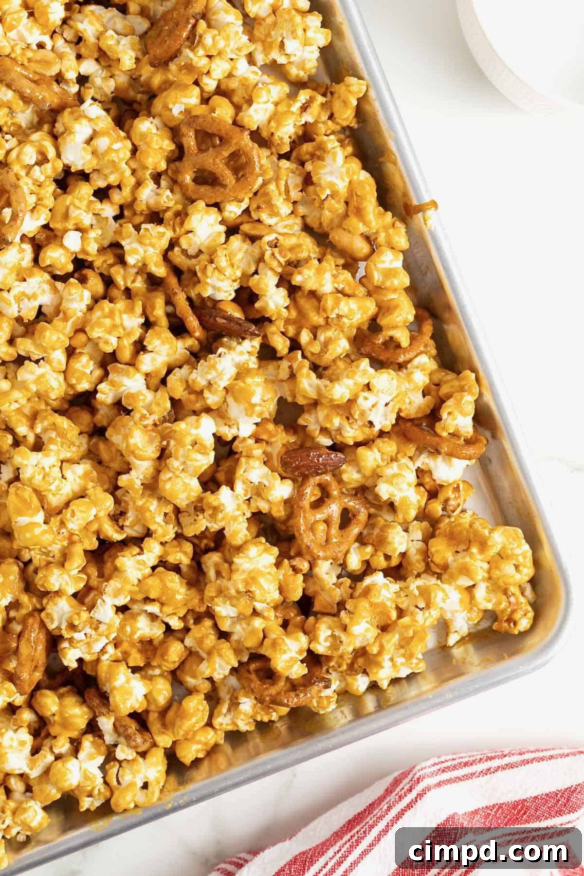 A baking sheet of baked caramel corn mix.