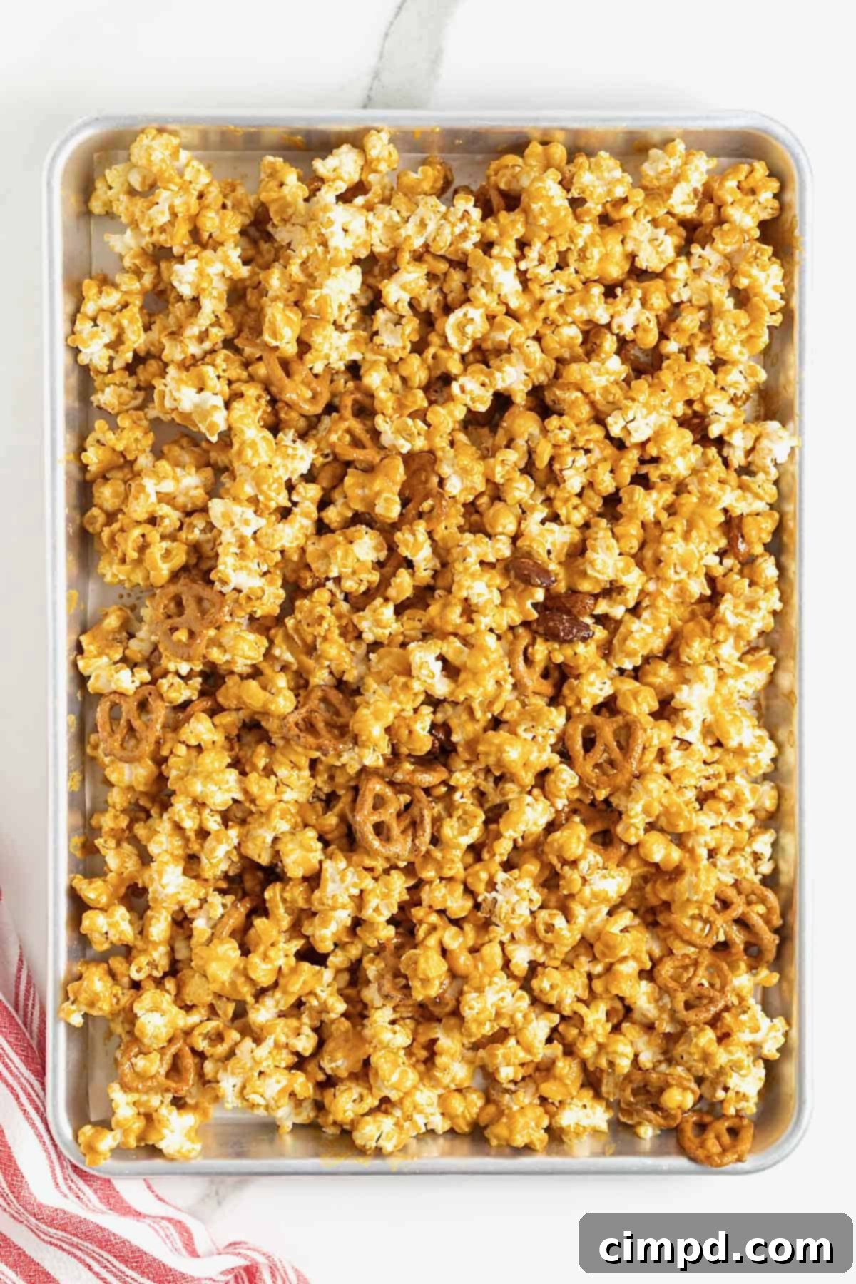 A baking sheet of baked caramel corn mix.