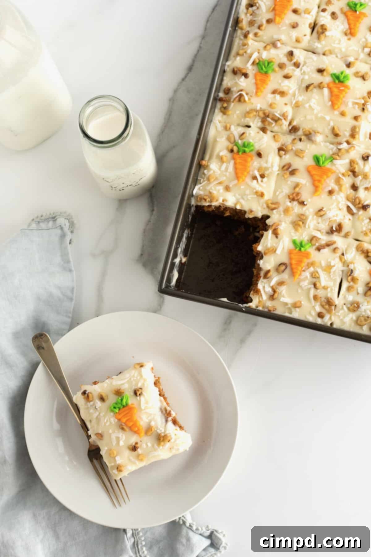 Perfectly Spiced Carrot Sheet Cake with Cream Cheese Frosting 4 Side view of Carrot Sheet Cake with a spatula, ready to be served, by The BakerMama