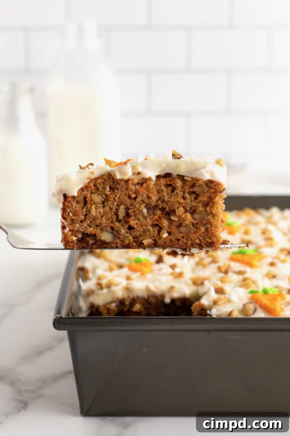 Perfectly Spiced Carrot Sheet Cake with Cream Cheese Frosting 5 A close-up of the delicious cream cheese frosting on Carrot Sheet Cake, by The BakerMama