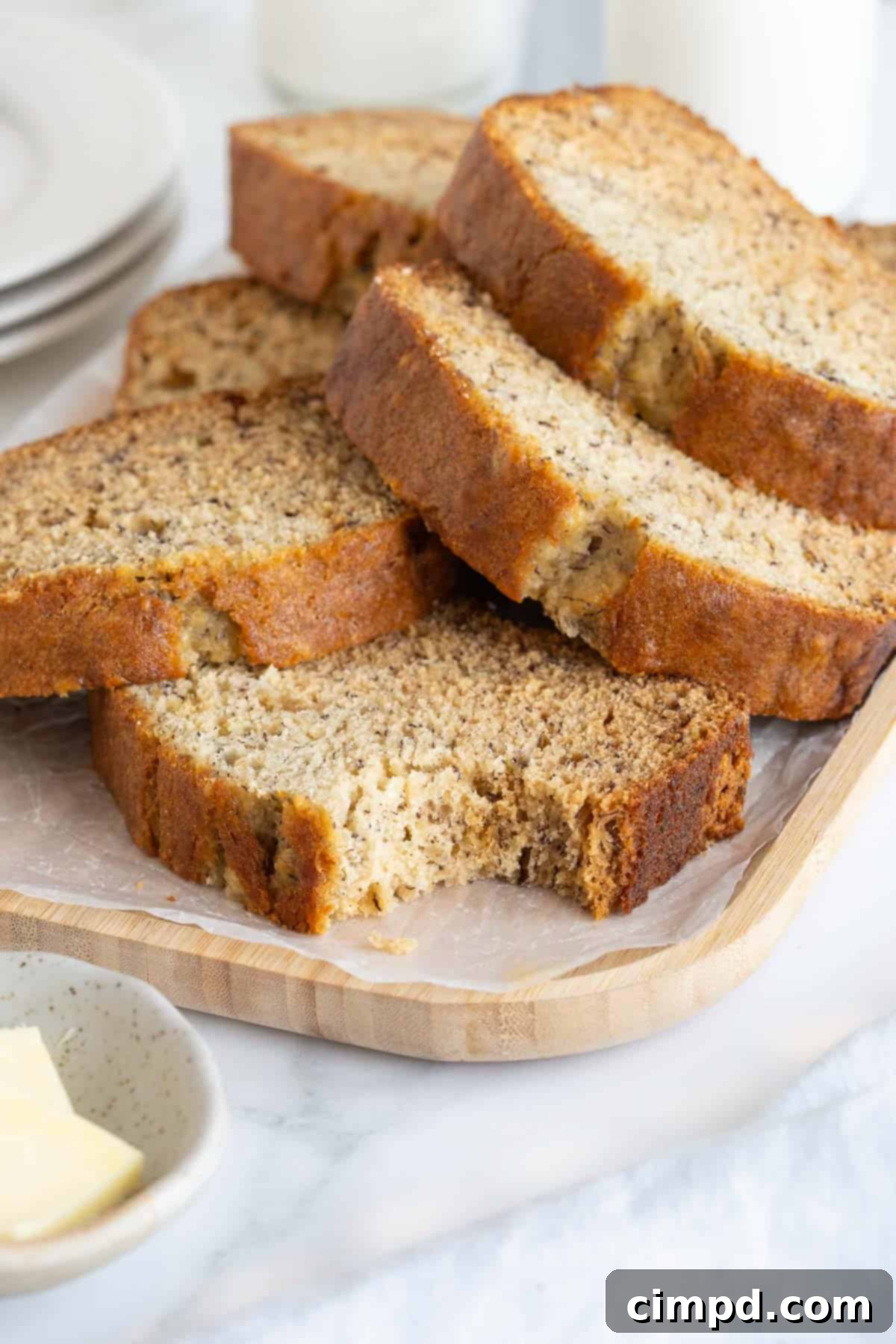 Next Level Brown Butter Banana Bread 3 A pile of slices of banana bread. The bottom slice has a bite out of it.