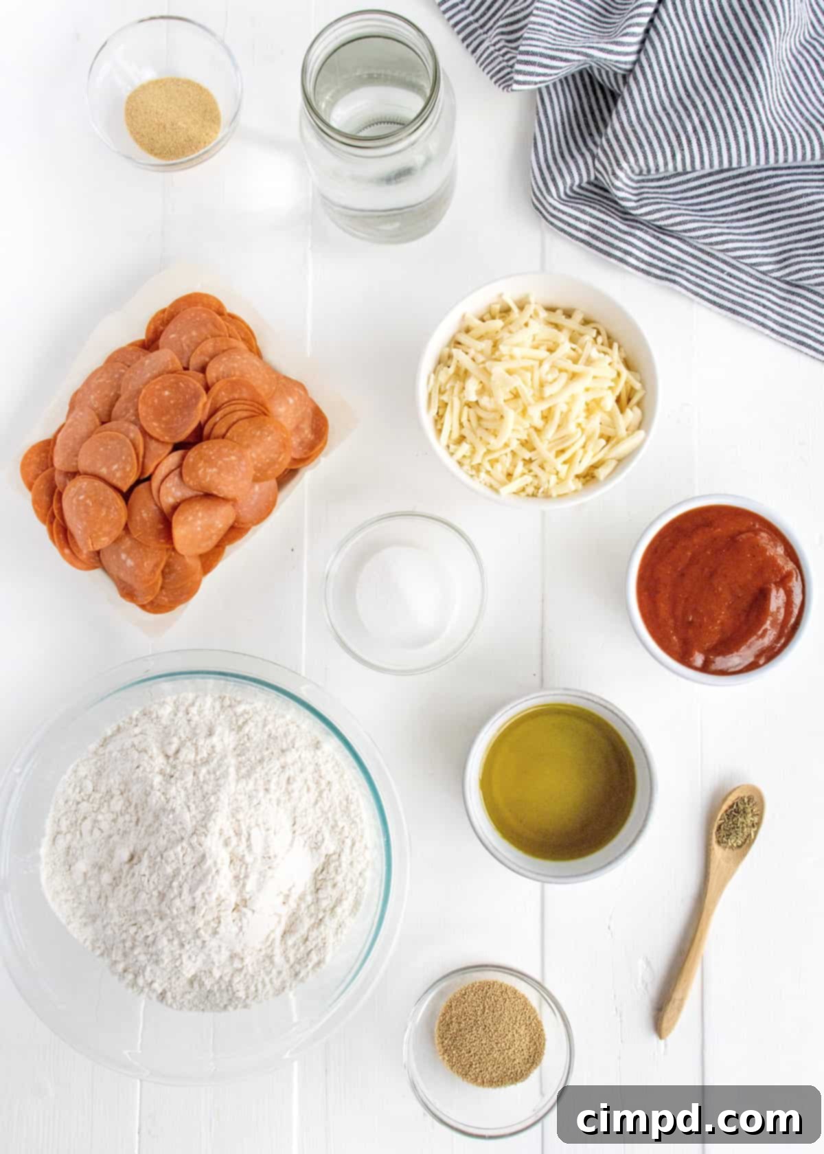 Tray-Baked Pizza Perfection 4 Ingredients for making a Sheet Pan Pizza, neatly arranged on a kitchen counter.