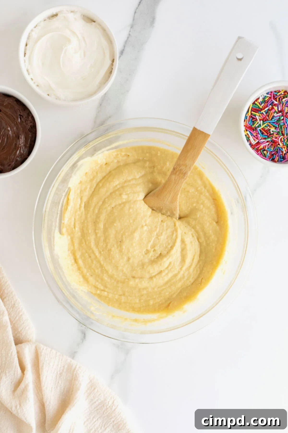 Effortless Cake Mix Baked Donuts 10 A close-up of smooth, pale vanilla cake mix donut batter, perfectly mixed and ready for piping into donut pans.
