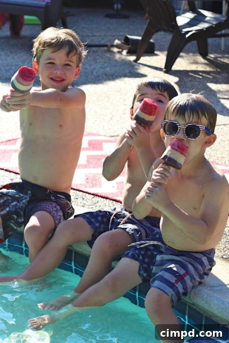 Close-up of a 3-Ingredient Patriotic Fruit Pop, showing the distinct red, white, and blue layers.
