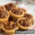 Pecan Pie Bites, a miniature holiday dessert on a white background.