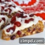 Stacked Cranberry Coconut White Chocolate Bars with a festive garnish
