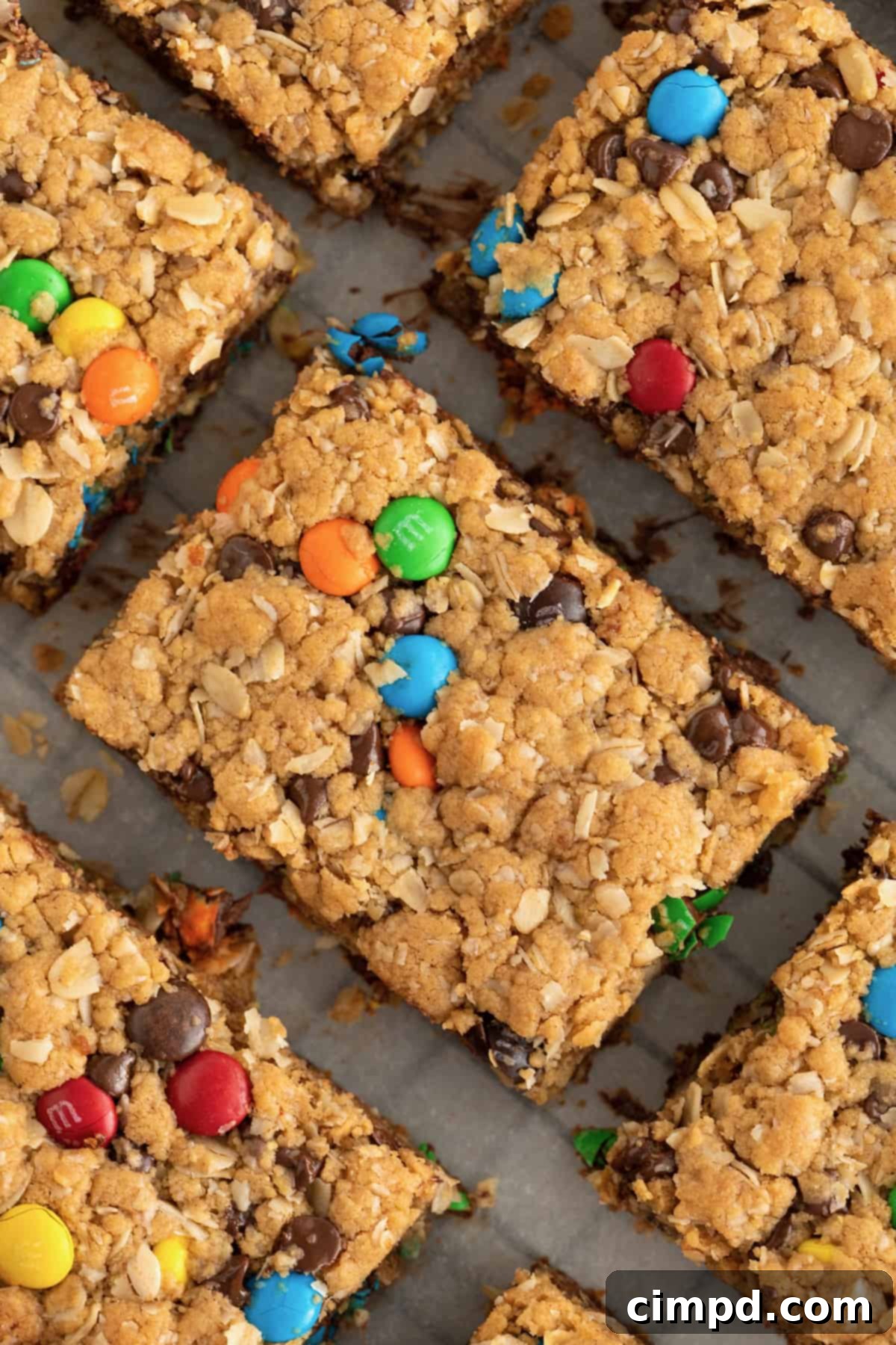 Irresistible Flourless Monster Cookie Bars cooling on a parchment-lined rack, ready to be devoured.