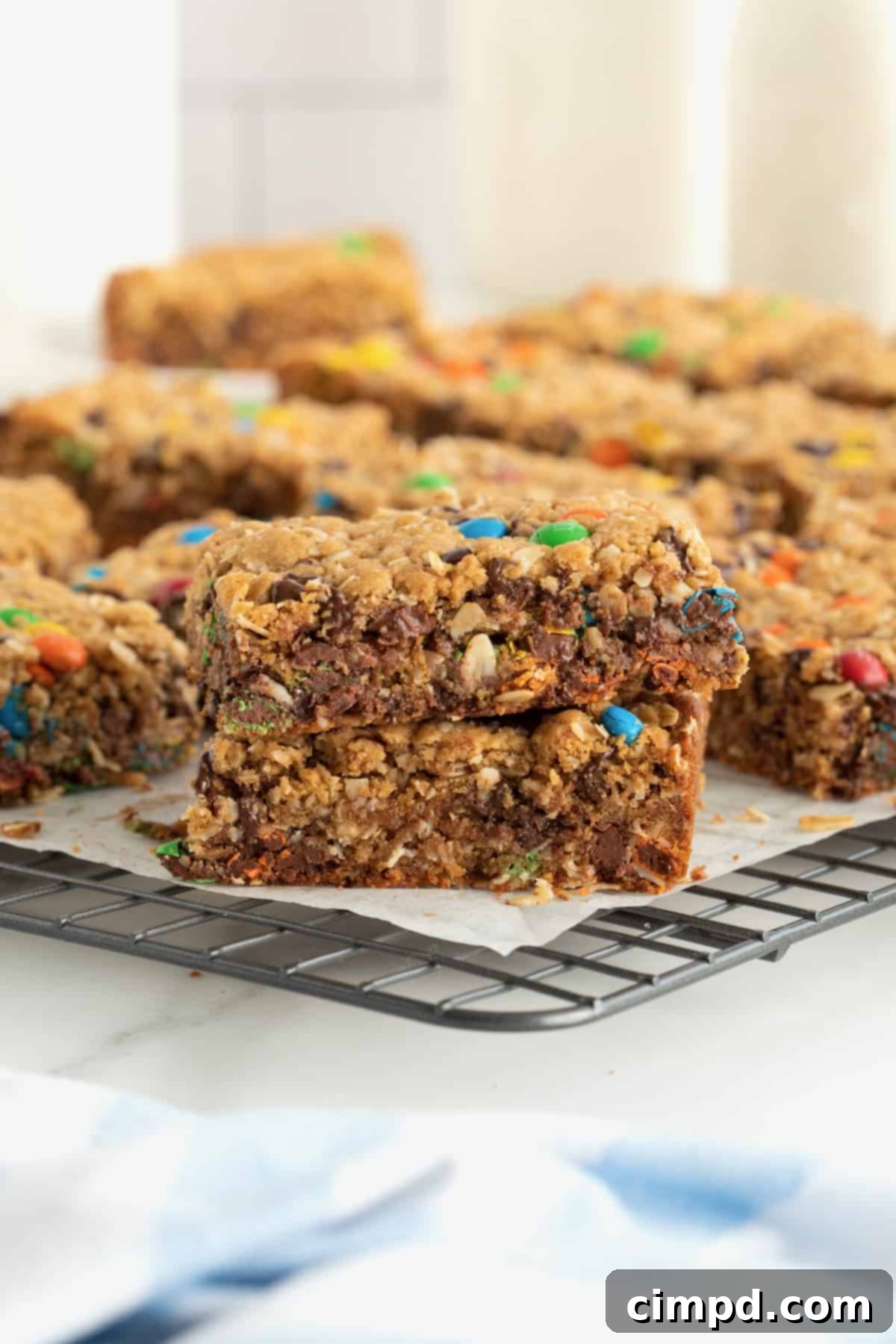 Close-up of perfectly baked Flourless Monster Cookie Bars on a cooling rack, highlighting their rich texture and tempting toppings.