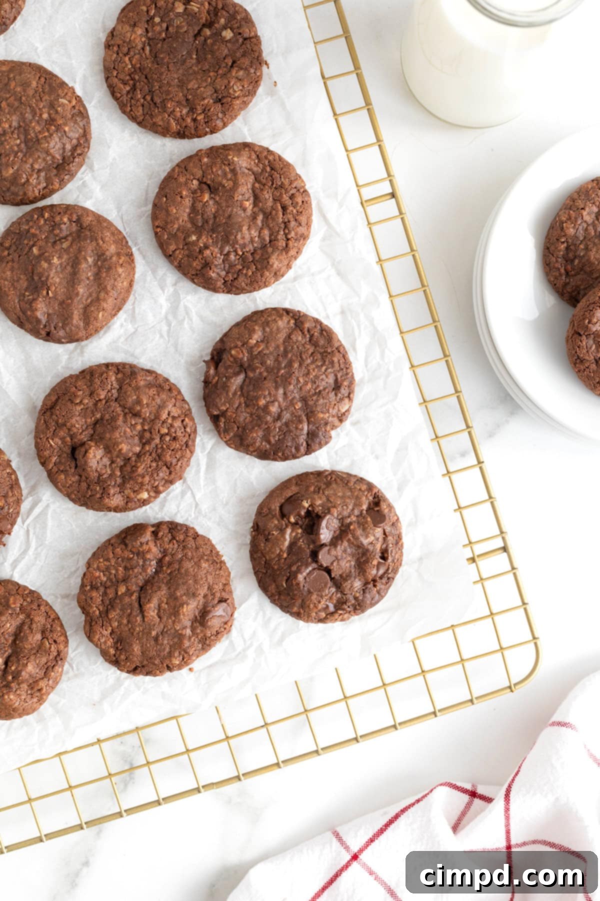 Nutella cookies cooling on a parchment lined metal rack.