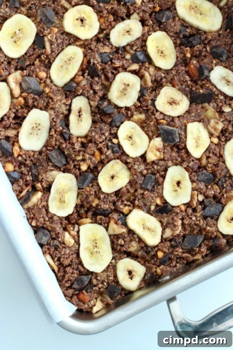 Hand holding a No-Bake Chunky Monkey Granola Bar, showcasing its texture and ingredients