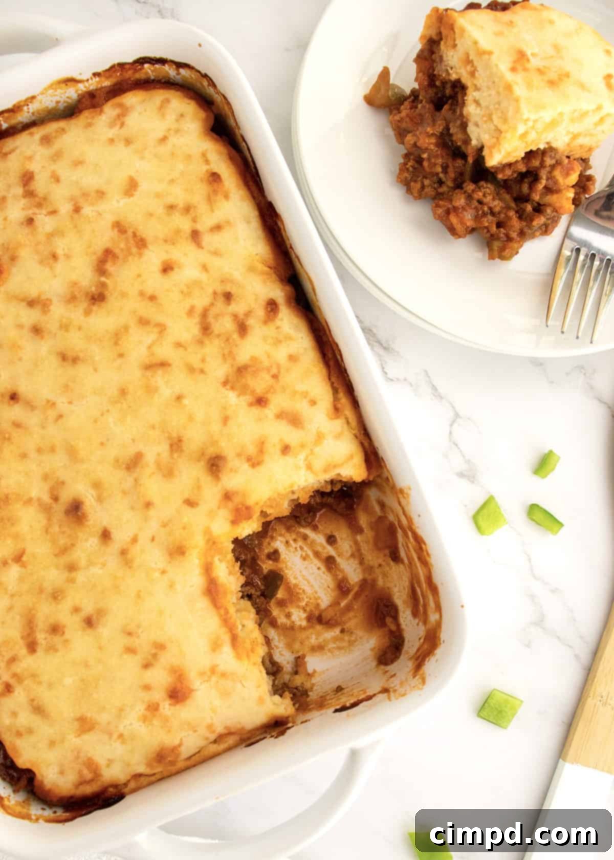 Sloppy Joe Supper Bake 3 A close-up view of the hearty Sloppy Joe Casserole, showcasing the bubbling meat filling and the golden-brown cheesy biscuit topping.