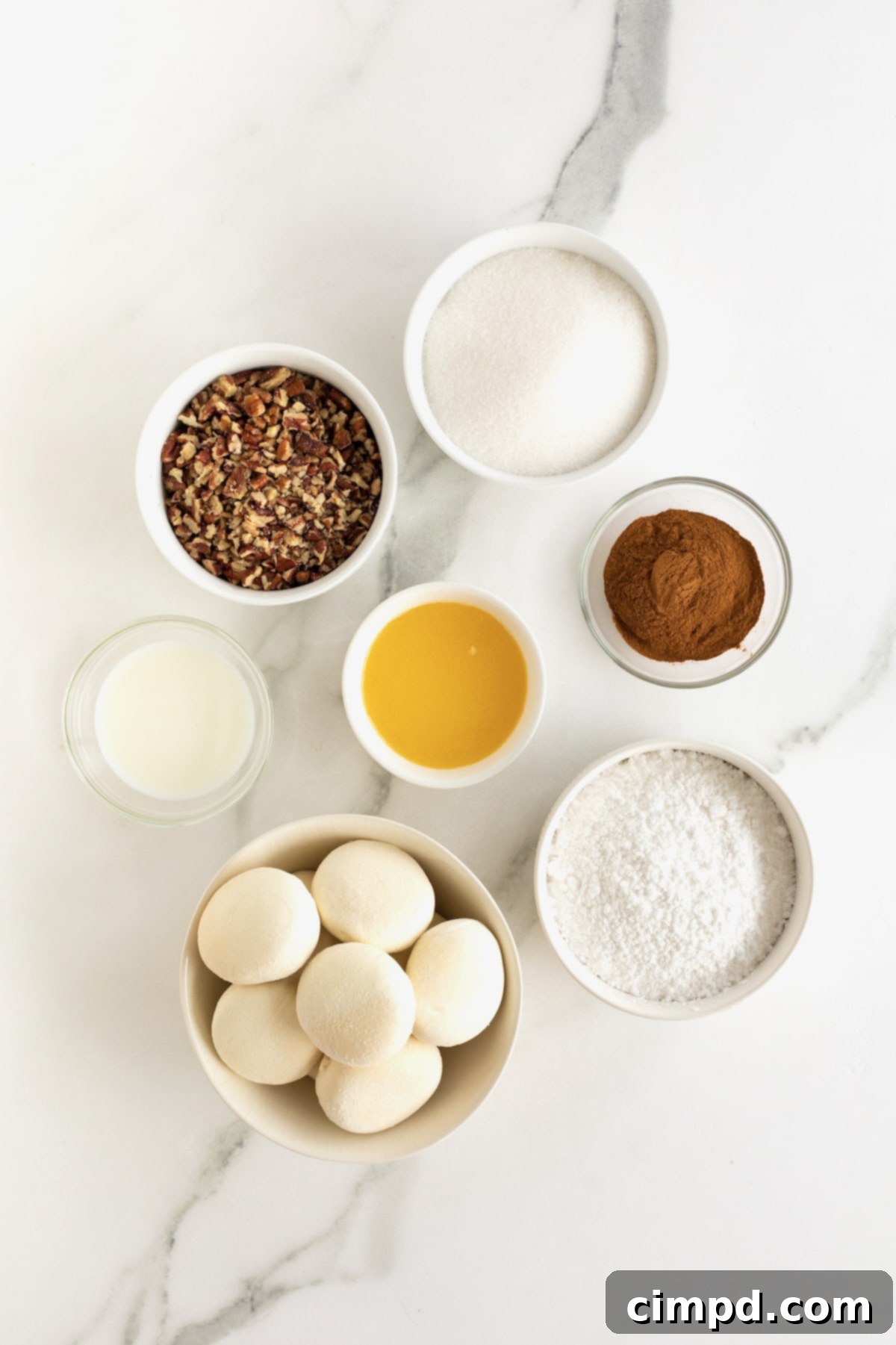 Easy Overnight Sweet Rolls 7 Ingredients for overnight sweet rolls in small glass dishes on a counter.