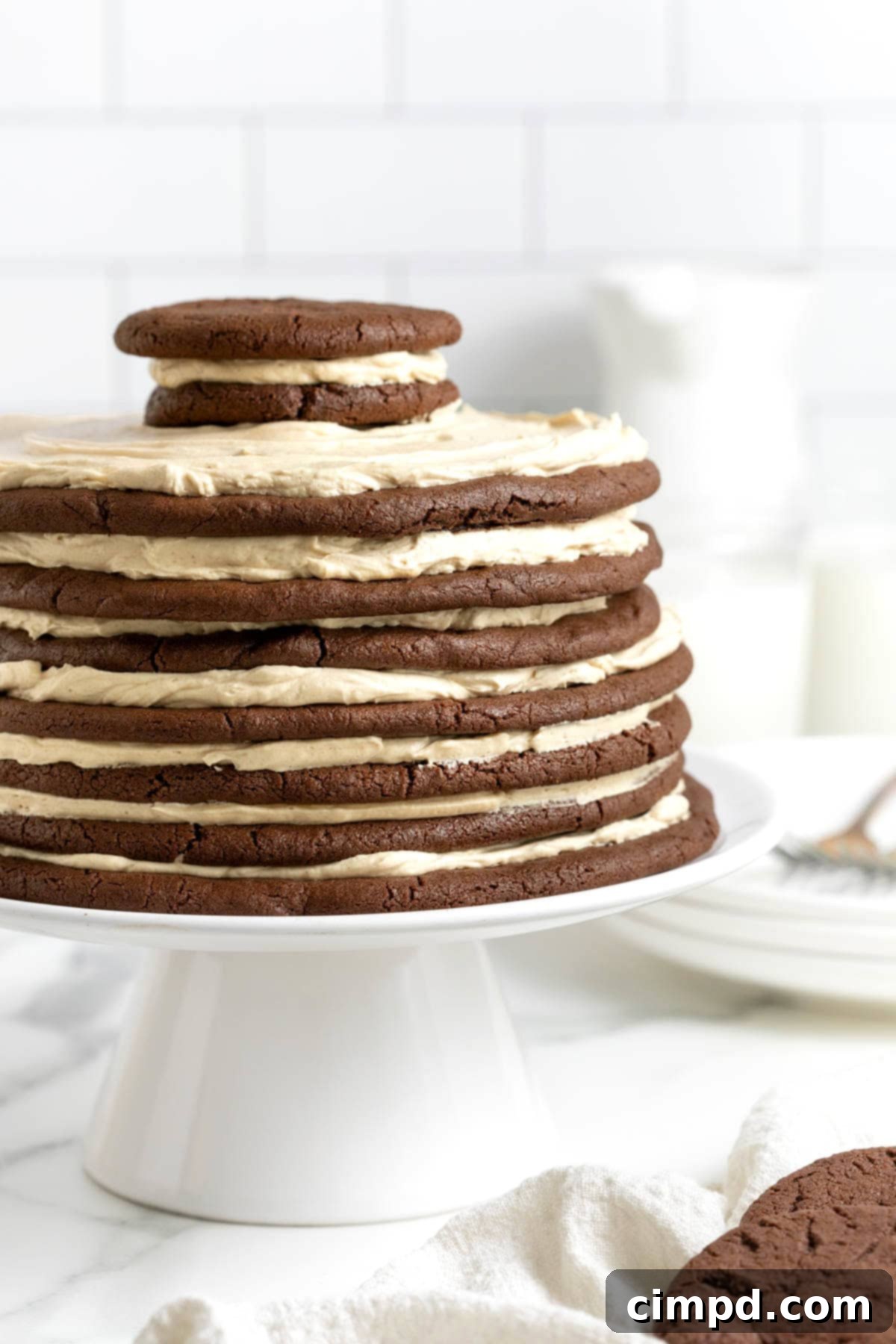 Decadent Peanut Butter Chocolate Cookie Tower 5 A full view of the chocolate peanut butter layered cookie cake, elegantly displayed on a white cake stand, ready to be served.