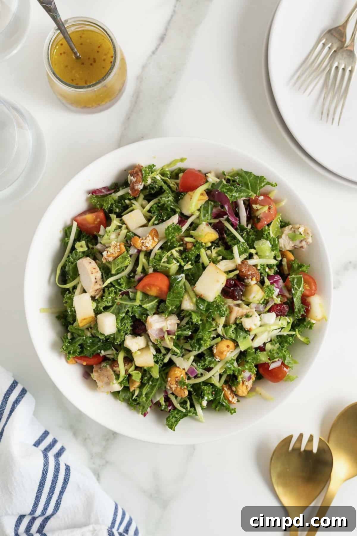 Quick 5-Minute Lunch Salad 11 A large white bowl of green salad with cut up tomatoes, shredded cheese and chunks of chicken.