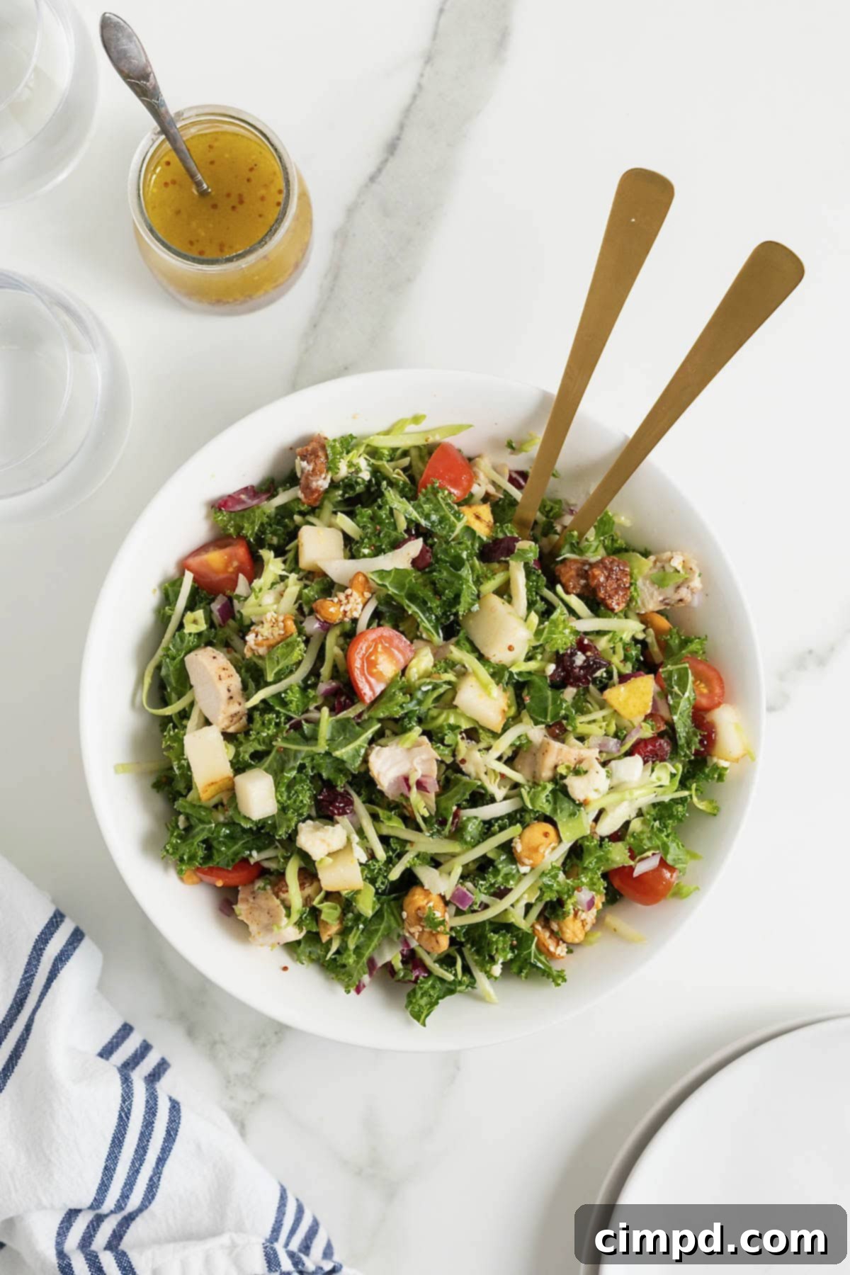 Quick 5-Minute Lunch Salad 4 A large white bowl of green salad with cut up tomatoes, shredded cheese and chunks of chicken.