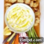 Velvety Ricotta Platter 2 Creamy whipped ricotta in a bowl on a wooden board surrounded by various dippers