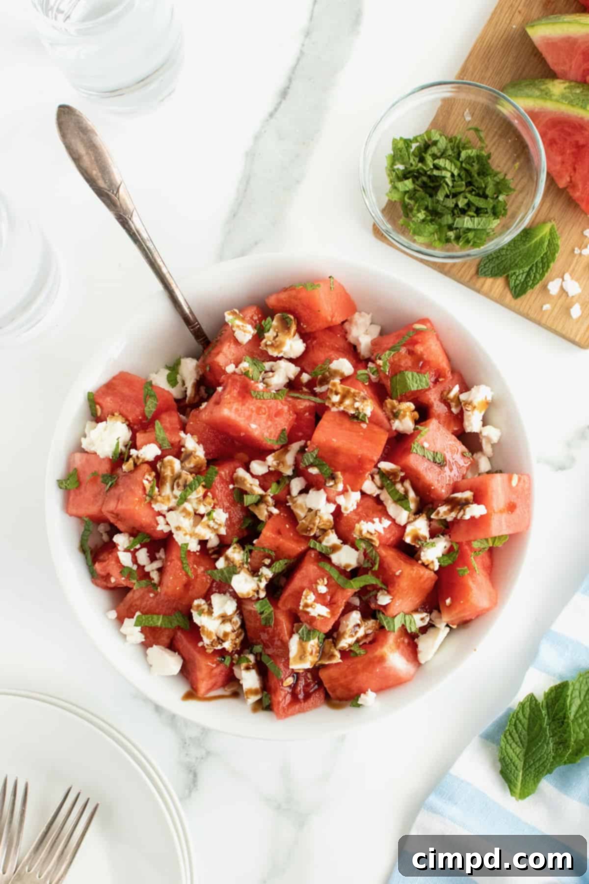 Close-up of Watermelon Feta Salad with fresh mint leaves and balsamic drizzle.