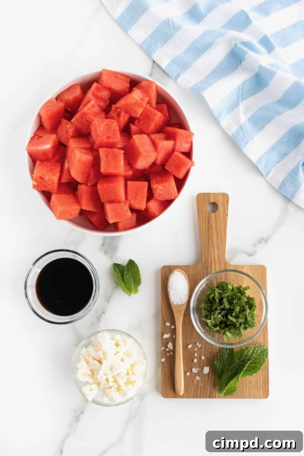 Bowl of Watermelon Feta Salad being drizzled with balsamic glaze.