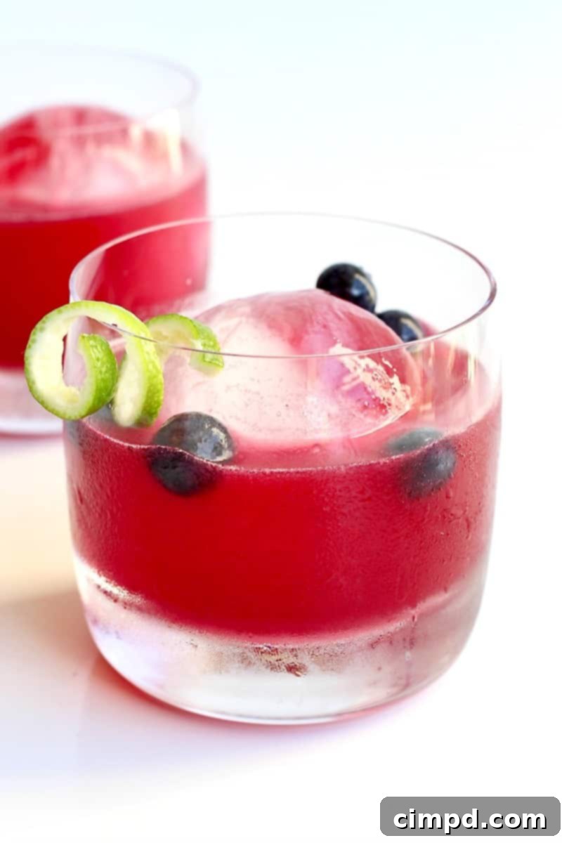 Azure Haze 2 A beautifully crafted Blue Smoke cocktail, a refreshing mix of mezcal, bourbon, and blueberries, garnished with fresh berries.