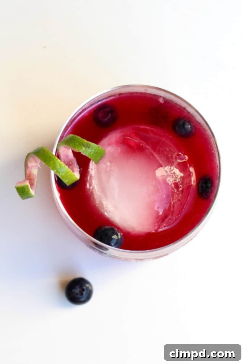 Azure Haze 3 Blue Smoke cocktail, a refreshing and perfectly balanced drink with mezcal, bourbon, and blueberry notes, ready to be enjoyed.