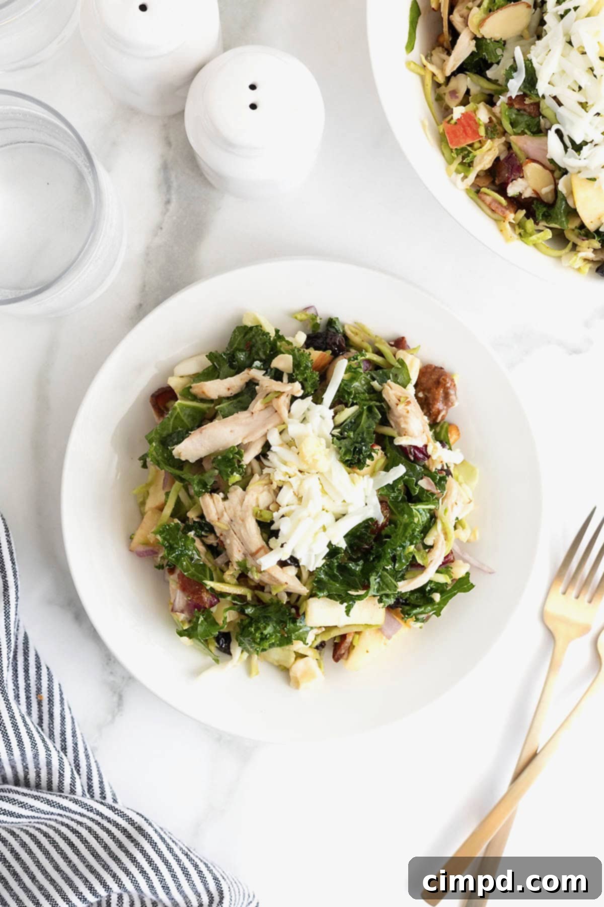 Newporter salad on a white salad plate next to a fork.