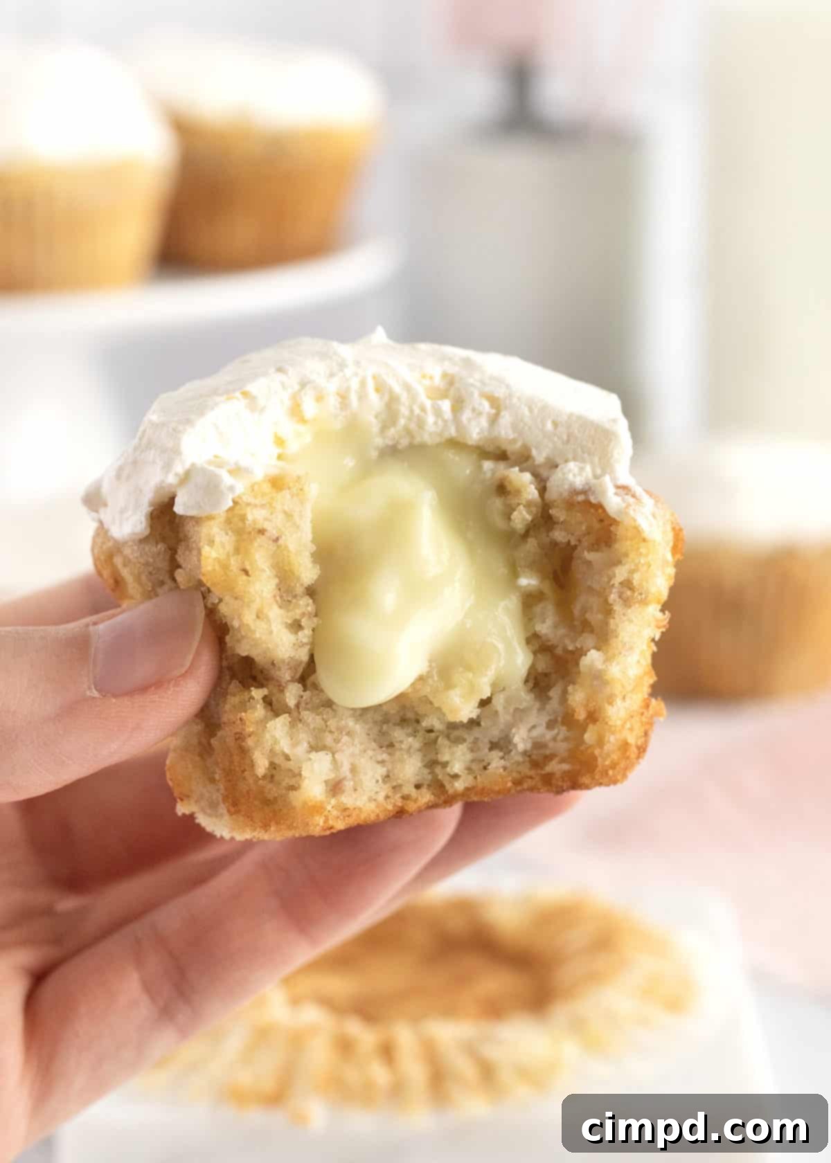 Close-up of a Banana Pudding Cupcake showing the creamy topping and cake layers