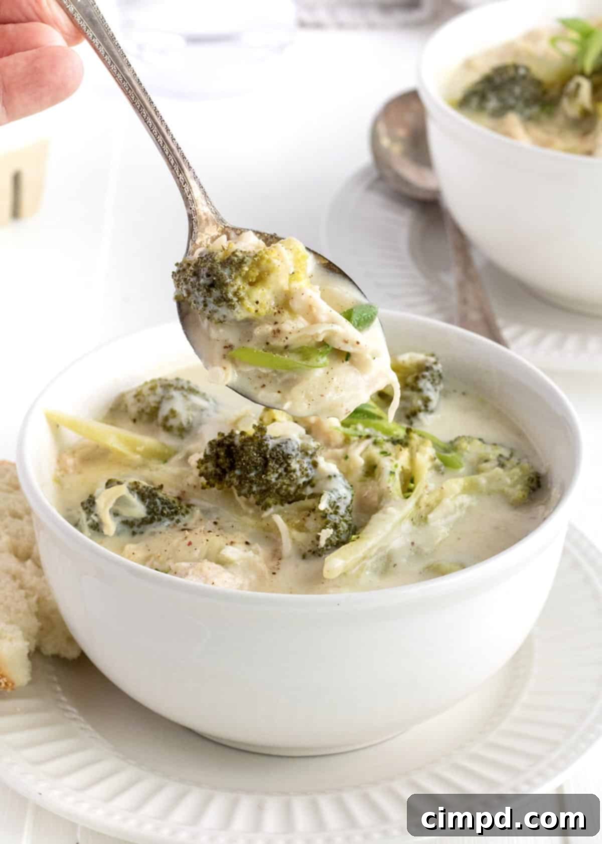 Hearty Broccoli Cheddar Chicken Soup 3 Close-up of a bowl of Broccoli Cheddar Chicken Soup, showcasing its creamy texture and visible pieces of chicken and broccoli