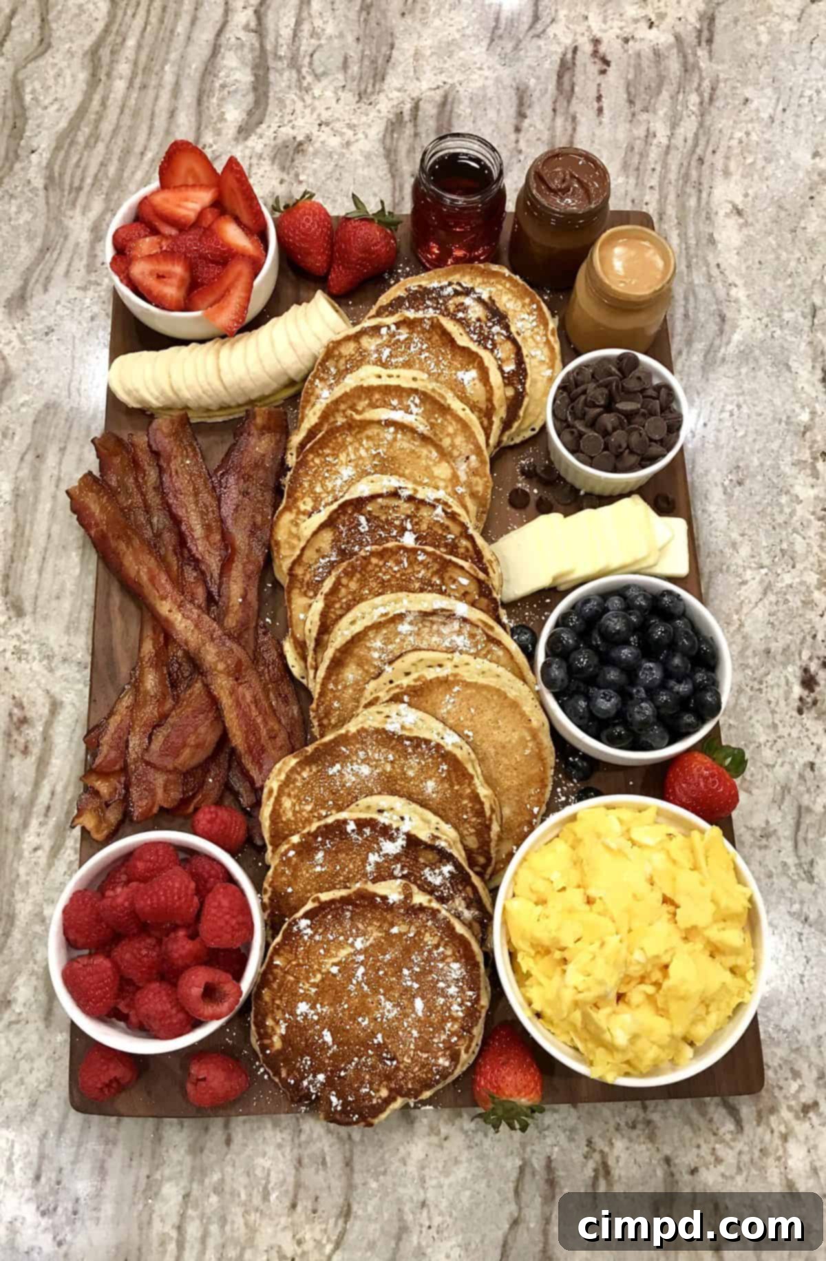 A lively image of a family or friends enjoying a beautifully presented Pancake Board together at the dining table, highlighting the interactive dining experience.