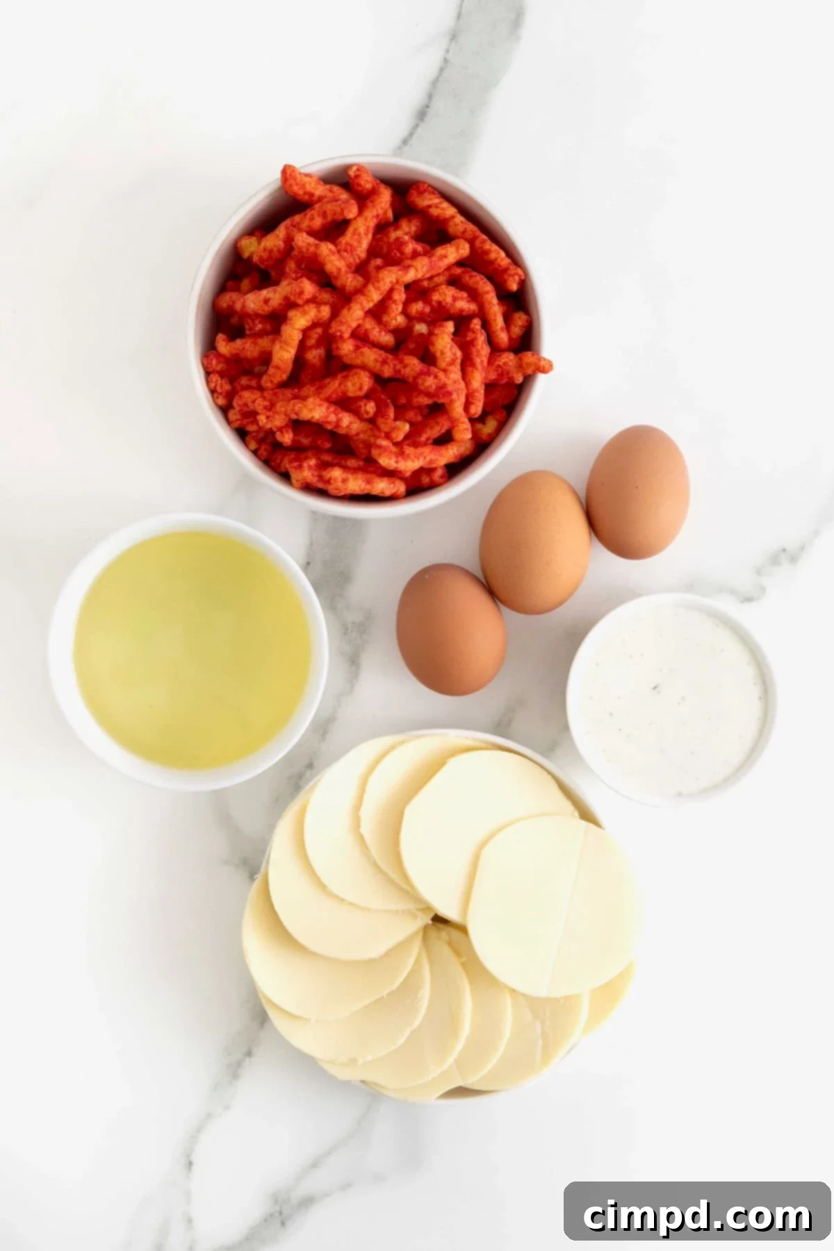 Fiery Cheetos Mozza Hearts 5 The ingredients for Flamin' Hot Cheeto Mozzarella Hearts beautifully arranged on a white marble countertop.
